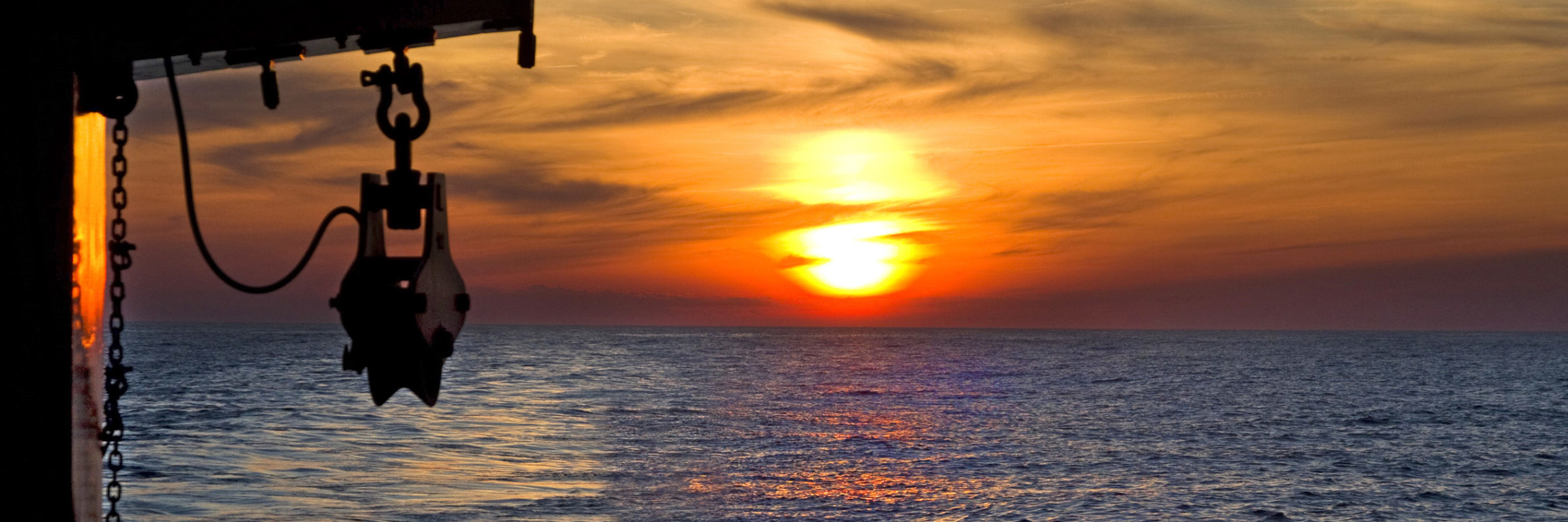 NOAA research vessel at sunset — voyages like this are the source for the Featured Lessons